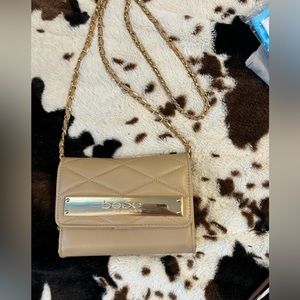 Bebe nude with gold bag